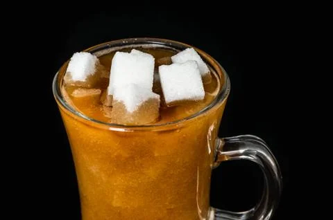 Many sugar cubes inside a cup of coffee - unhealthy eating concept Stock Photos