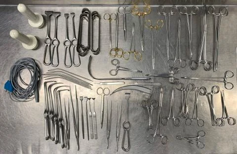 Many Surgical instruments lie sorted next to each other on an operating table Stock Photos