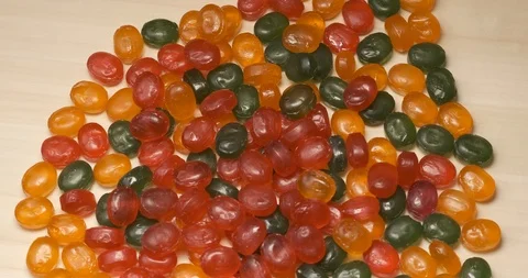 Many of sweets lie on rotating table, multi-colored sweets, caramel, junk food Stock Footage 119054765