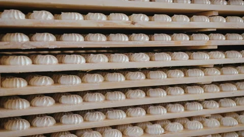 Many sweets white marshmallow stored in wooden racks in the warehouse of the 스톡 동영상 106425286