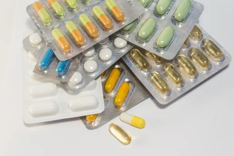 Many tablets / pills on white background - blister packs Stock Photos