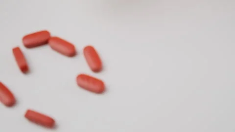 Many tablets spill on white background. Pills falling, drugs, antibiotics, vitam Stock Footage 277438370