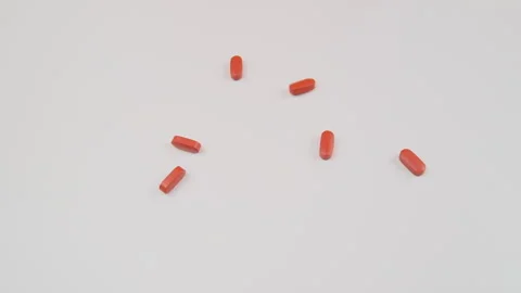 Many tablets spill on white background. Pills falling, drugs, antibiotics, vitam Stock Footage 279316916
