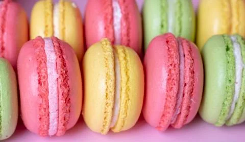 Many tasty macarons background, close up. French concept Stock Photos
