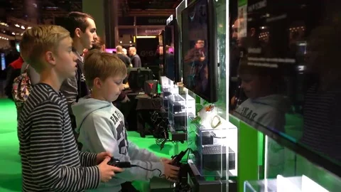 Many teens are testing new games from Xbox using a gamepads Stock Footage 69230970
