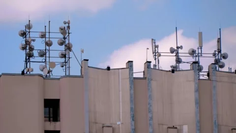 A many of telecommunication receiving and transmitting antennas on the roof  Stock Footage 318699151