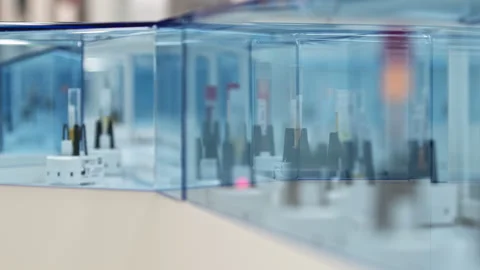 Many test tubes moving around in different directions on an automated lab glazed Stock Footage 233128419