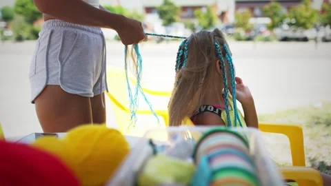Many threads and ribbons lie on the table against the background of a girl whose Stock Footage 348024069