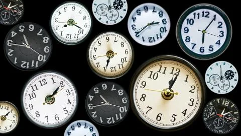 Many time clock faces appear showing different  time. Various clocks in busy  Stock Photos