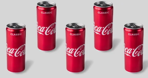 Many tin coca cola cans animated on a gray background close-up Stock Footage 134864830