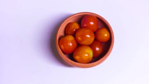 Many Tomatoes in a Cup Are Isolated On White Background Video stock 170153807