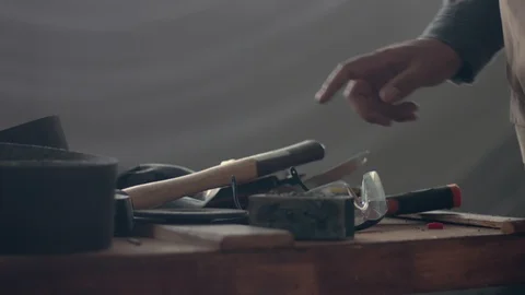 Many tools on the worker table and his hand choosing one of tool Video stock 86618761