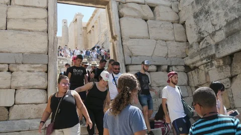 Many tourists walking inside in Acropolis, Athens on a sunny day in summer Stock Footage 117715863