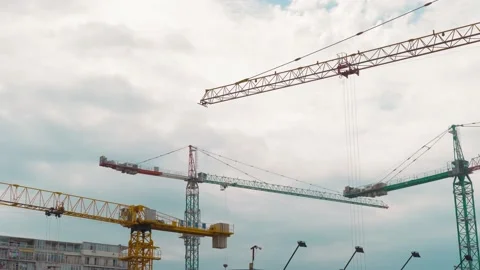 Many tower cranes work on construction site. They move and build building. Stock Footage 213954665