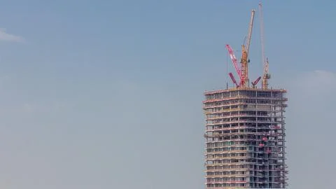 Many tower cranes working on the construction site of new skyscraper of the m Stock Photos