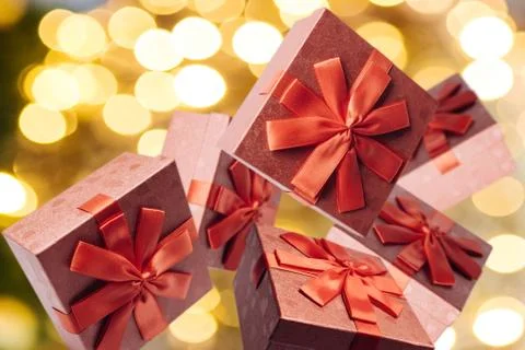 Many traditional gift boxes fall on a festive background. Stock Photos