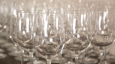 Many Transparent Empty Wine Glasses Close-up. Abstract blurred background. Video stock 109420362