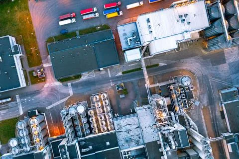 Many trucks are waiting for loading near the warehouse in the factory, aerial Stock Photos