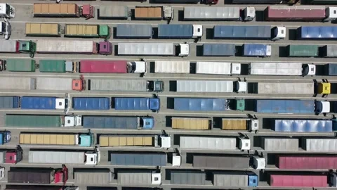 Many trucks waiting in line for unloading at the port. Transportation and Stock Footage 134914757