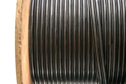 Many turns of the main electrical cable is closeup. Roll of outdoor fiber opt 库存照片