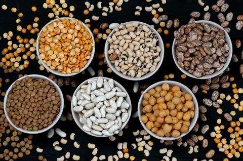 Many types of beans scattered around the bowls Stock Photos