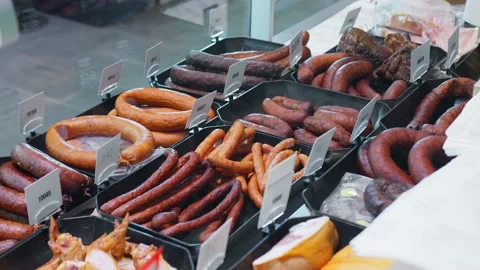 Many types of sausage lying in the window of a store or supermarket for sale Video stock 131527100