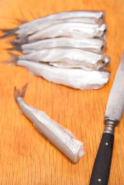 Many uncooked trunk small fish on wood Stock Photos