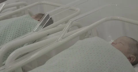 Many unknown newborn babies lying in separated baby hospital bed Stock Footage 127744715