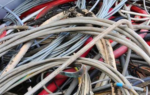 Many used old electrical cords in a recycling container for copper recycling Stock-Fotos