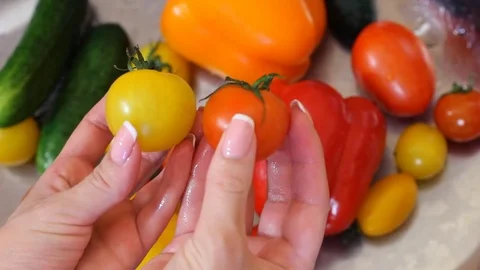 Many vegetables of various kinds lick in the sink and are ready for washing. Red Stock Footage