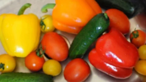 Many vegetables of various kinds lick in the sink and are ready for washing. Red Stock Footage 77560670
