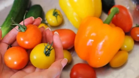 Many vegetables of various kinds lick in the sink and are ready for washing. Red 스톡 동영상 77601861