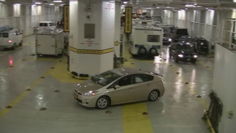 Many vehicles being placed into position for parking on Alaskan ferry. Stock Footage 79411010