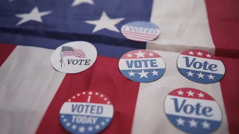 Many "Voting" stickers against the backdrop of the American flag Vidéo 348382766