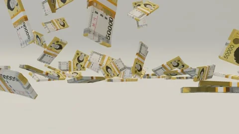 Many wads of money falling on table. 50000 South Korean Won banknotes.  Stock Footage 172357604
