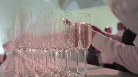 Many Waiter's on the work and Hand Pours Champagne Into Glasses In the party Stock Footage 145660741