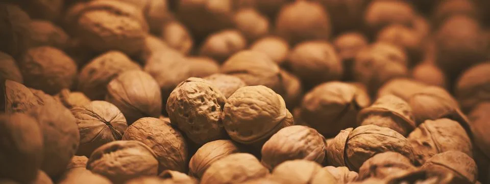 Many walnuts in strong shells are found in large quantities in the grocery st Stock Photos