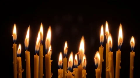 Many wax thin candles burn brightly. Religion concept. Video stock 181574724
