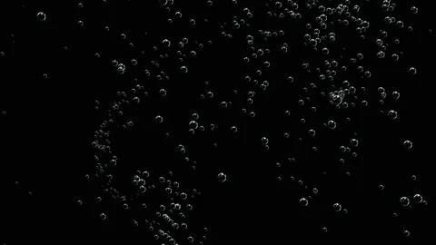 Many white bubbles spin slowly on a black background. Stock Footage 125999373