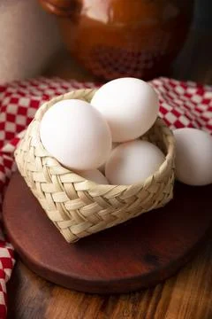 Many white chicken eggs on rustic wooden table. Very popular nutritious and e Stock Photos