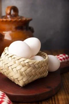 Many white chicken eggs on rustic wooden table. Very popular nutritious and e Stock Photos