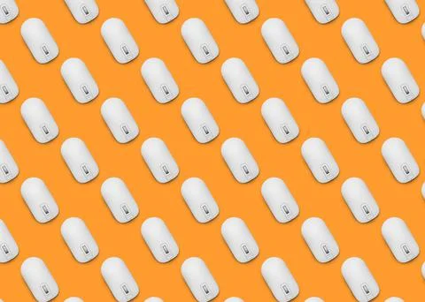 Many white computer mouses on orange background, flat lay. Seamless pattern d Stock Photos