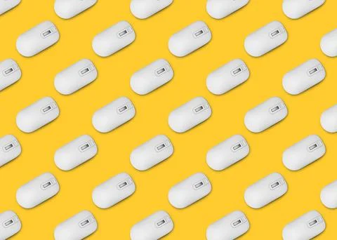 Many white computer mouses on yellow background, flat lay. Seamless pattern d Stock Photos