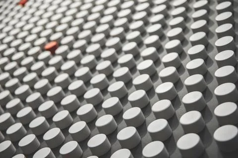 Many white dots with splashes of red on a gray background, abstract background Stock Photos