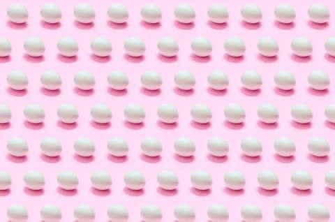 Many white eggs on solid color background Stock Photos