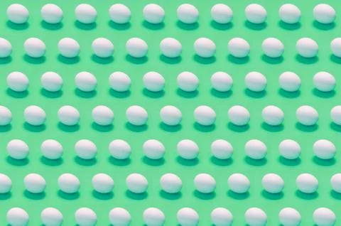 Many white eggs on solid color background Stock Photos