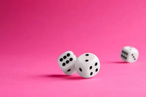Many white game dices falling on pink background. Space for text Stock Photos