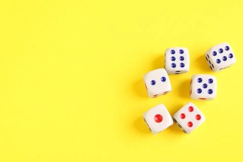 Many white game dices on yellow background, flat lay. Space for text Stock Photos