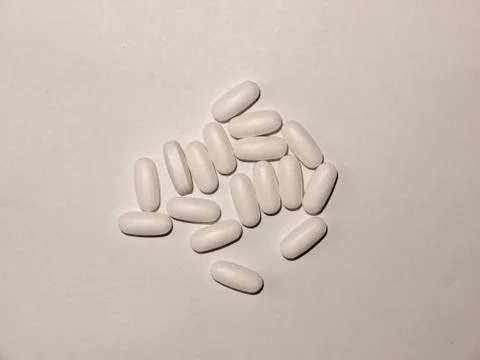 Many white generic tablet pills on a white background Stock Photos
