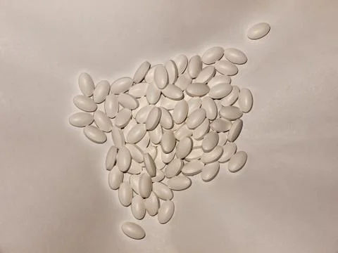 Many white generic tablet pills on a white background Stock Photos